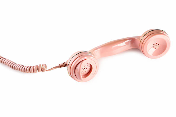 Pink telephone handset isolated on a white