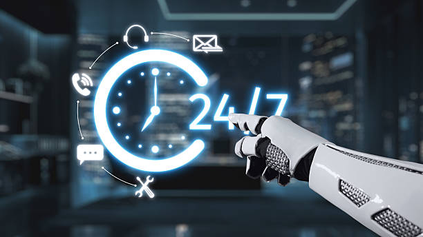 istock Futuristic robotic hand pointing at glowing 24-hour clock with communication icons symbolizing constant availability and modern technology in a cityscape background. Auvana 2215272773