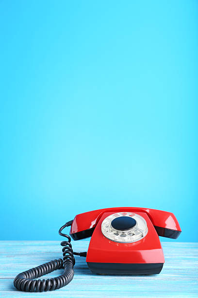 istock Red retro telephone on wooden table 2215273467