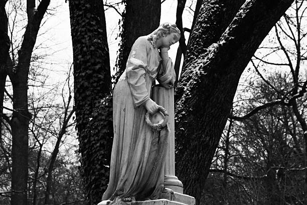 Statue of a sad lady in a cemetry