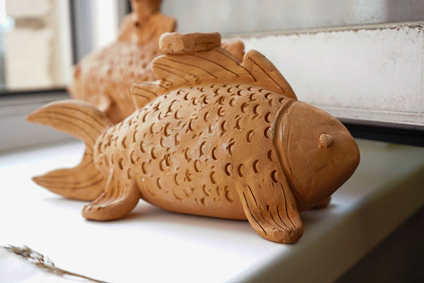 istock Miniature fish-shaped made of clay on a white background 2215275149
