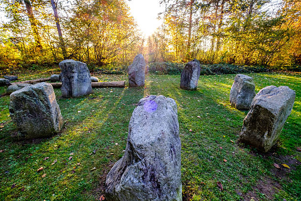istock Mysterious stone circle in a lush green forest illuminated by soft sunlight during early evening hours 2215275295
