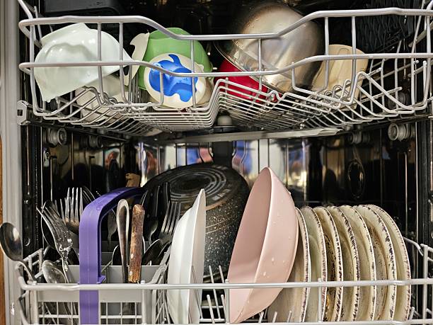istock Dishwasher filled with dishes waiting to be washed 2215275509