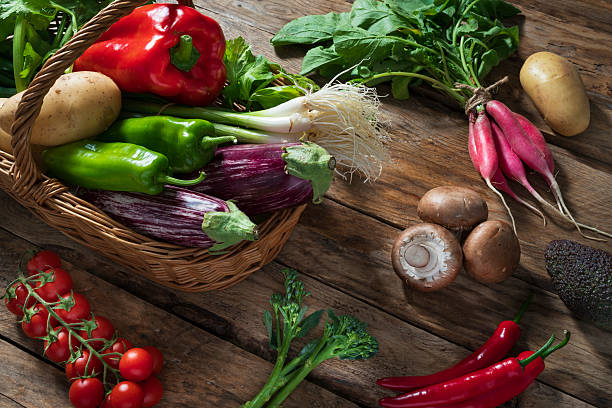 Fresh multicolored vegetables on wood background