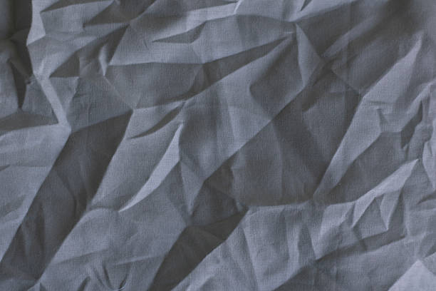 Close-up of wrinkled gray fabric with textured patterns and natural folds