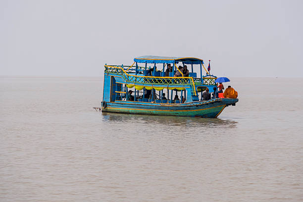 Cambodian little girl rowing a boat on Tonle Sap, Cambodia
