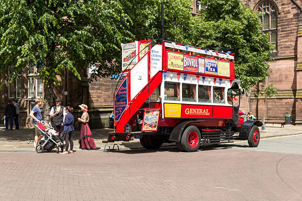 View of a vintage tour bus in the centre of Chester, UK.  People can be seen on the bus and the promenade
