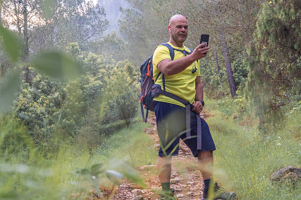 istock Man in the forest taking a selfie with the phone 2215280110