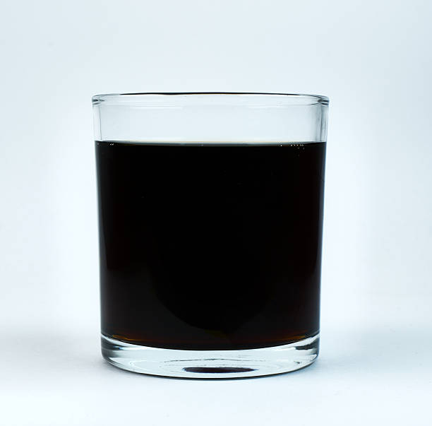 istock Dark drink served in a clear glass cup on white background 2215283111