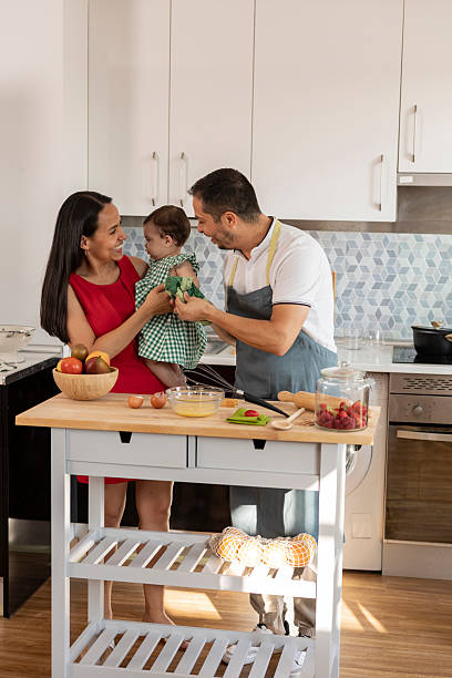 istock Hispanic family cooking together in modern kitchen 2215283383