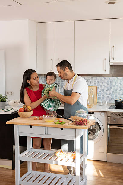 istock Hispanic family cooking together in modern kitchen 2215283385