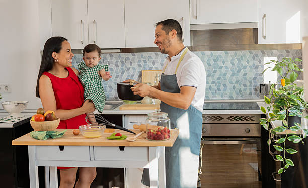 istock Latin family cooking together in modern kitchen 2215283391