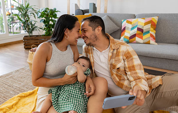 istock Happy latin family taking a selfie while baby drinks milk 2215283403
