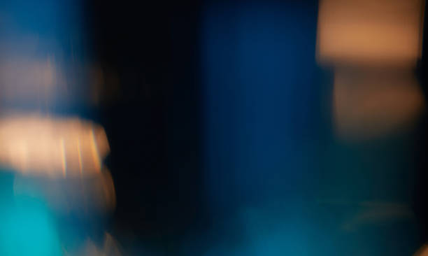 Abstract light leaks on black background with copy space. Studio lens flare bokeh effect.