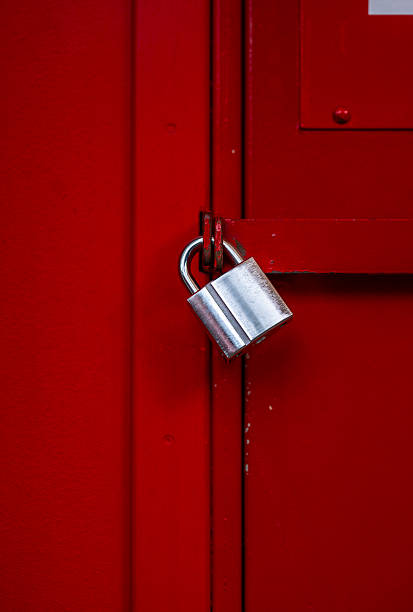 istock silver padlock on red metal door.. 2215287203