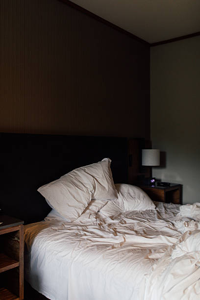 istock unmade, slept-in bed in hotel room 2215287447