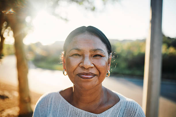 istock Smiling Woman in Sunlit Outdoor Setting 2215288127