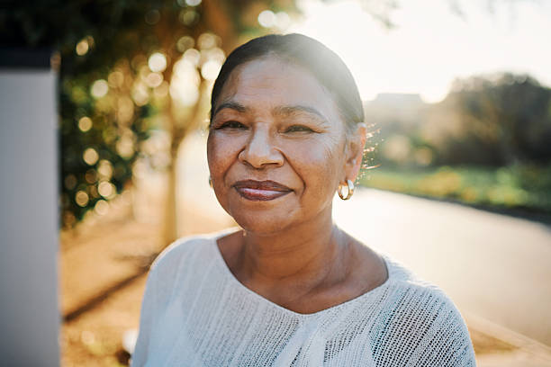 istock Smiling Woman in Sunlit Outdoor Setting 2215288135
