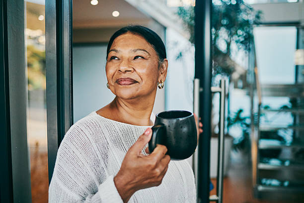 istock Smiling Woman Enjoying Coffee in Modern Space 2215288151