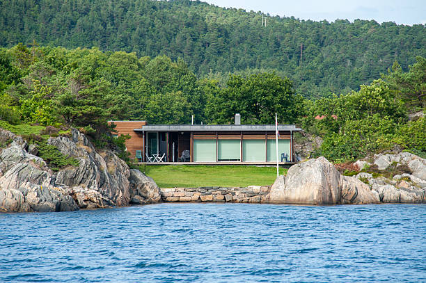 modern waterfront house surrounded by nature.