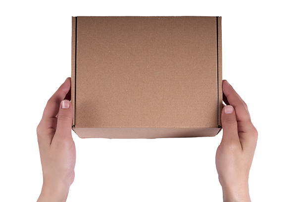 istock Hand Holding Closed Cardboard Box 2215289695