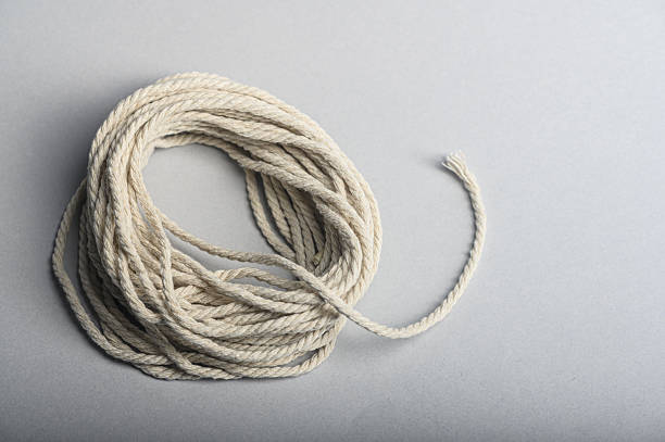 curved sea rope hanging on blue sky background
