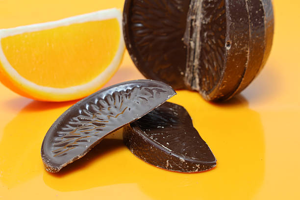 Orange flavor chocolates isolated on a orange background.