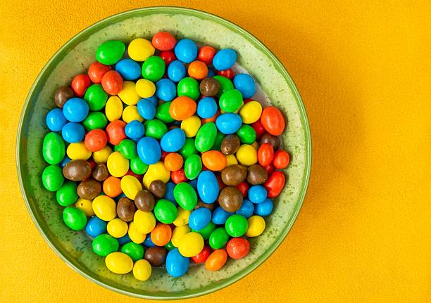 istock Colorful candy-coated chocolates in a bowl. 2215294649