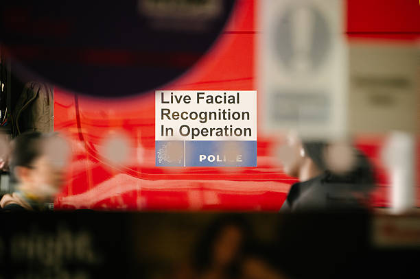 Detail of a police car with a Live Facial Recognition in Operation sign
