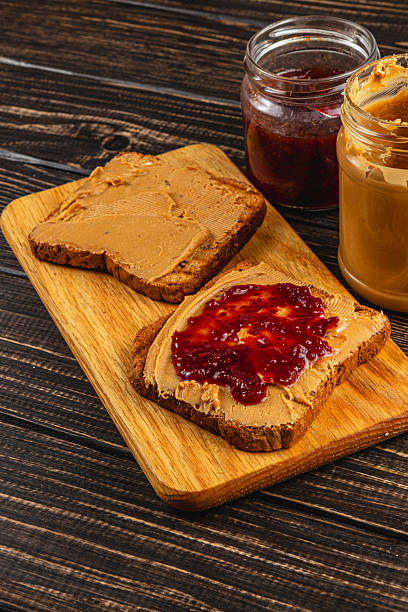 istock Making a PB&J sandwich on a wooden board 2215296583