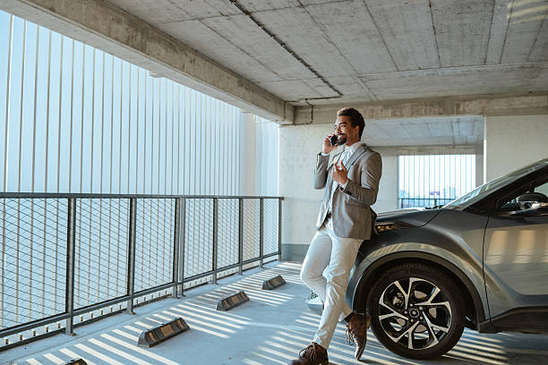 istock Professional man making a phone call in a modern parking area 2215297808