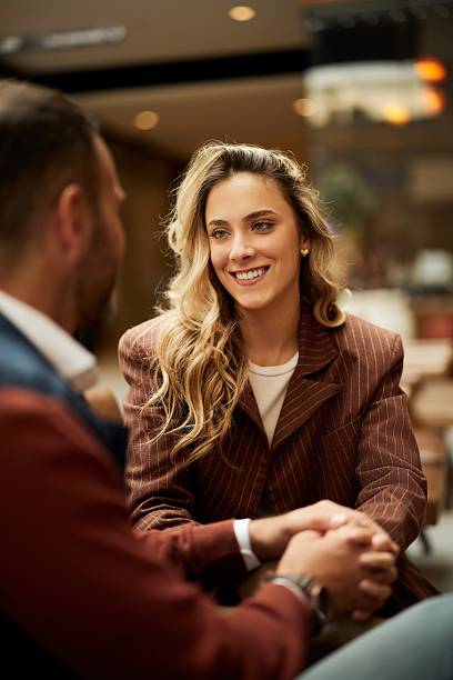 istock Smiling Woman Engaged in Conversation at a Cozy Cafe Setting 2215299402