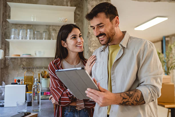 istock happy couple stand in the kitchen and use digital tablet together 2215302867