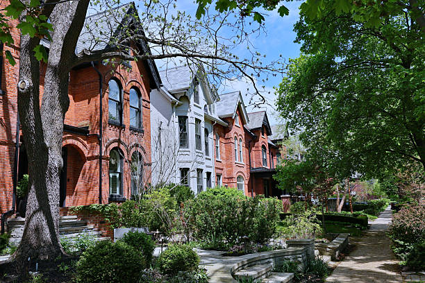 istock Tree lined street with old brick houses with gables 2215303246