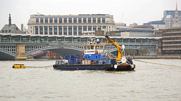 London, United Kingdom - November 17, 2013: Tugboat Work Barge With Crane Williams Shipping at Thames River Cold Winter Day.