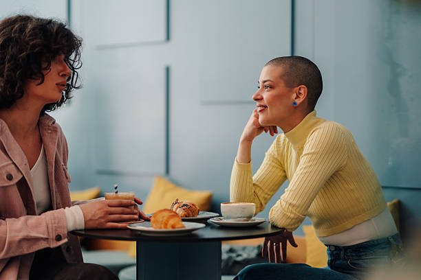 istock Two young women talking and having breakfast at the cafe 2215311199