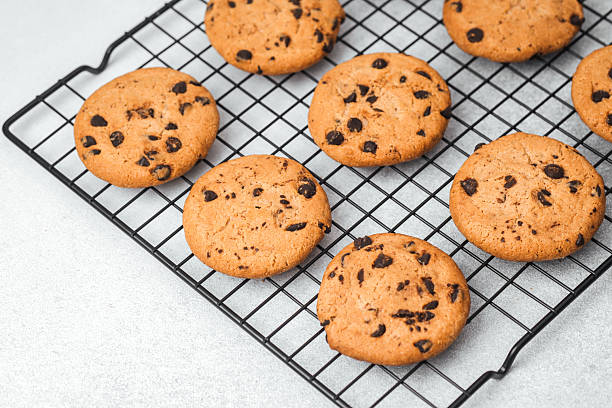 istock Freshly baked cookies cooling on a wire rack in a kitchen setting 2215312637