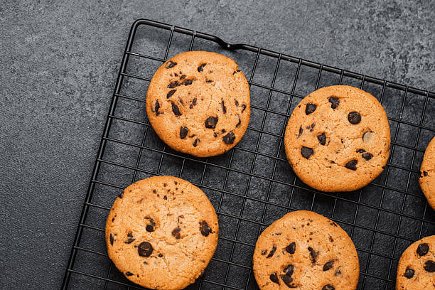 istock Freshly baked chocolate chip cookies cooling on a wire rack 2215312655