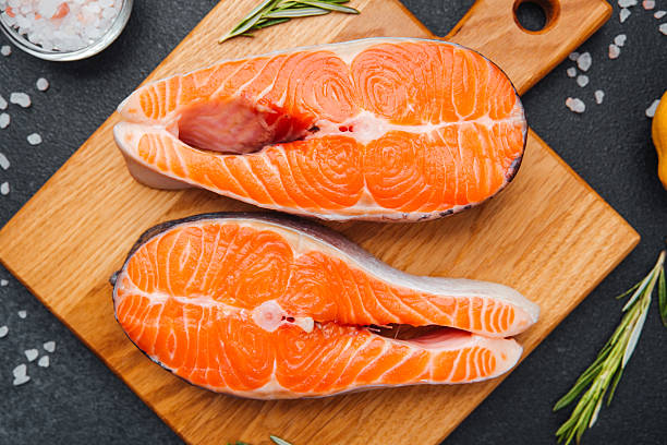 istock Fresh salmon fillets ready for culinary preparation with herbs and spices 2215312673