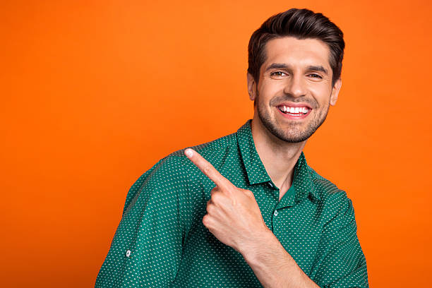 istock Photo of young targetologist man handsome direct finger empty space useful information how get new job isolated on orange color background 2215313960