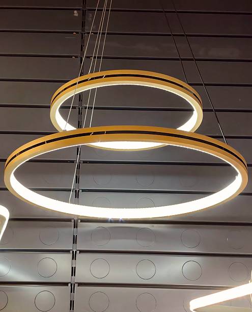 istock modern ring-shaped ceiling lights illuminate contemporary interior space during daylight hours. 2215314502