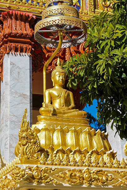 istock Buddha gold statue in a Buddhist temple Wat in Thailand 2215317779
