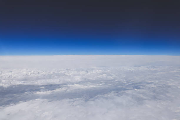 clouds stretching across the horizon under a vibrant blue sky,