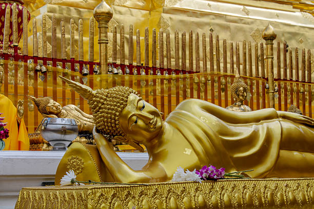 Buddha gold statue in a Buddhist temple Wat in Thailand. Golden Statue of Gautama Buddha sacred relic of Thai Buddhism religion. Decoration of thai wat with beautiful golden figure of sitting Buddha