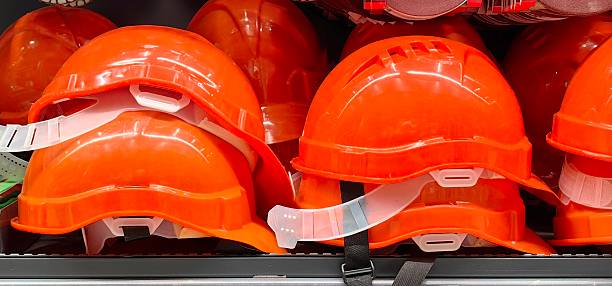 istock bright orange safety helmets displayed on shelf in hardware store during daylight hours. 2215319603