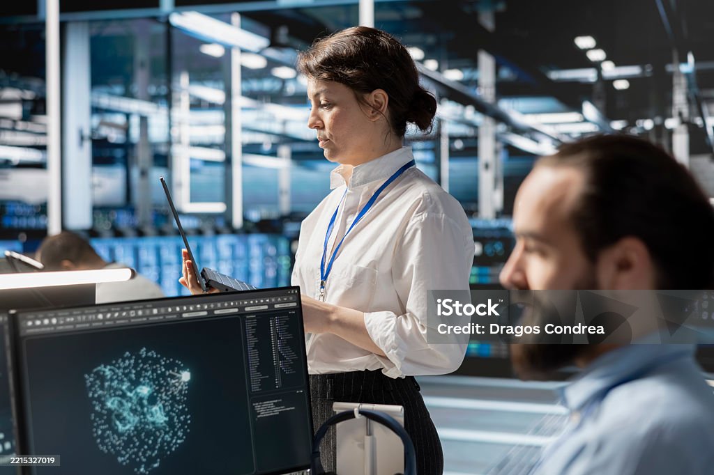 Admin Using Computer Admins Using Computer In Data Center Office Running Scripts Stock Photo ...