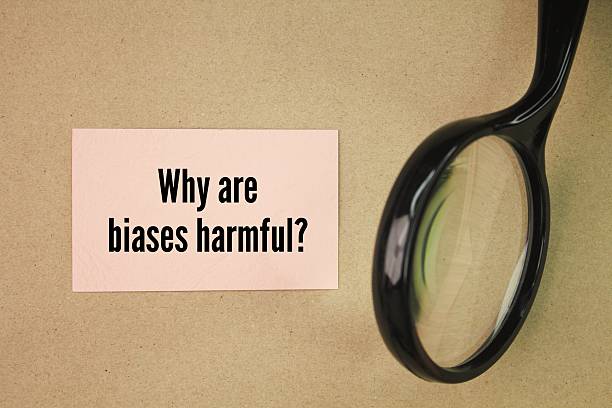 istock Magnifying glass and paper with the question words Why are biases harmful? 2215332473
