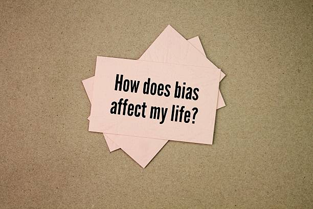 istock colored paper with the question words How does bias affect my life? 2215332986