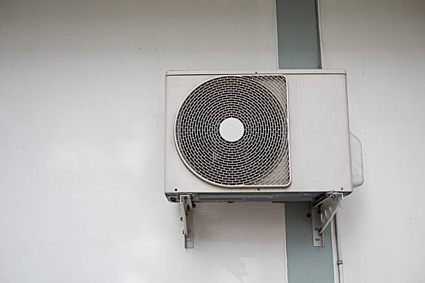 istock The air conditioner is installed outside the building on a white wall. 2215336395