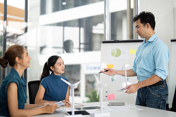 istock Team Collaboration on Sustainability. Discussing renewable energy projects in a modern office. 2215336608